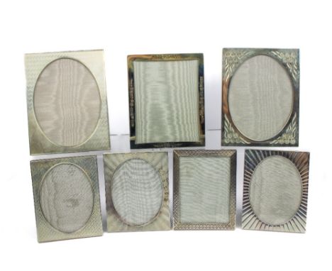 Seven silver photograph frames with various decorated borders and strut back supports, all London, two 1992, 1982, 1988, 1989