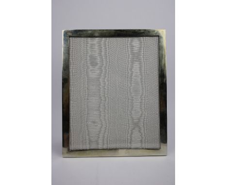 A silver photograph frame with a plan border and strut back support, London 2008, 23.2cm X 28.3cm. Markers mark for Richard L