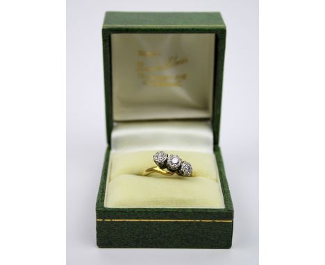 A Diamond three stone ring, illusion-set with three brilliant cut diamonds. Ring size O, stamped 18ct &amp; Plat