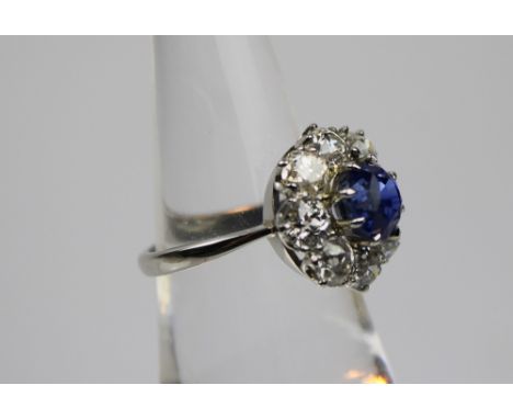 Sapphire and Diamond cluster ring, set with a circular sapphire surrounded by old-mine cut diamonds set in platinum, ring siz