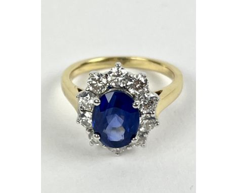 Sapphire and Diamond cluster ring, set with an oval sapphire surrounded by brilliant-cut diamonds, ring size J, Condition : G