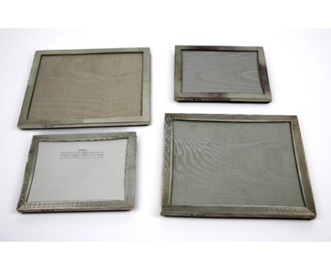 Four silver photograph frames decorated with various borders and strut back supports, all London, two 1998, 1991, 1994, large