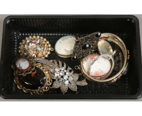 A collection of costume jewellery including marcasite and white paste spray brooch, cameos and a gilt bangle etc.