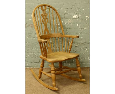 A light oak spindle back rocking chair.