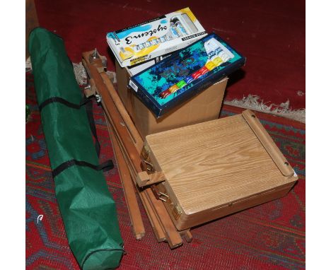 A quantity of artists equipment including easels, oils paints, a paint box / travel easel etc.