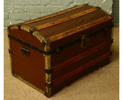 A dome top wood and metal bound trunk.