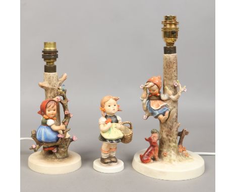 Two Goebel figural tablelamps by M. J. Hummel and another figure modelled as a girl with a basket. Condition Report. To be us