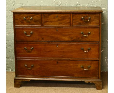 A George III mahogany chest of drawers with cock beading and raised on bracket supports.