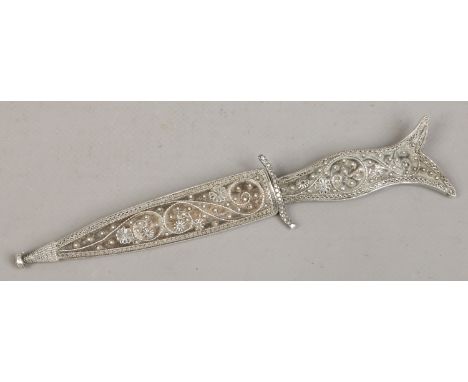 An Eastern white metal knife in scabbard decorated with filigree work. (Length 17cm, Blade 9cm)