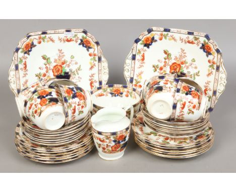 An Edwardian bone china part tea service with gilt and floral decoration including tea cups and saucers, sandwich plates, mil