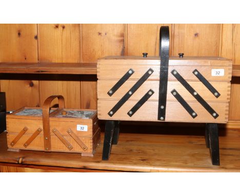 A light oak cantilever sewing box along with a smaller example.