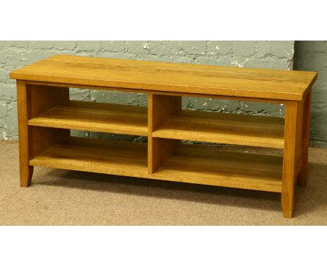 A light solid oak coffee table with four compartments.