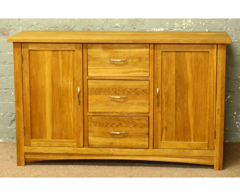 A modern solid light oak sideboard.