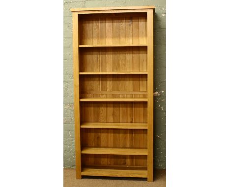 A large light oak open bookcase.