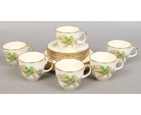 A Tunstall six place tea service decorated with flowers and gilt work.