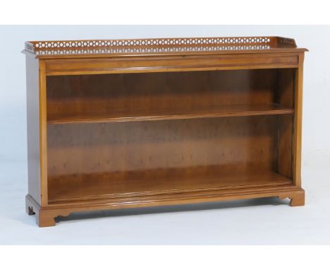 Quality modern yewood open bookcase, having a three quarter gallery back and two shelves, raised on bracket feet, width 153cm