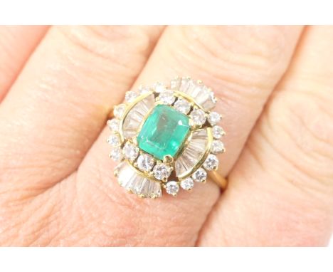 Emerald and diamond cluster ring, the central step cut emerald of approx. 1ct, 6mm x 5mm, bordered with baguette diamonds in 