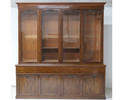 Early Victorian mahogany secretaire library bookcase, circa 1840, having a cavetto moulded cornice over four glazed doors, op