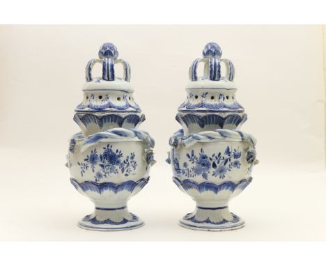 Pair of delft blue and white pot pourri jars, traditional form with pierced cover with bud and leaf finial, the body decorate
