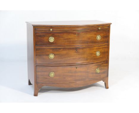 Late Regency mahogany bow front bachelor's chest, circa 1830, having a brushing slide over three graduated long drawers, each