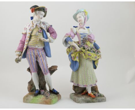 Pair of Dresden porcelain figures of gardeners, after Meissen, circa 1870, each modelled in 18th Century costume, decorated t