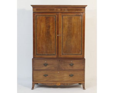 Late George III mahogany and inlaid linen press, circa 1800, having a cavetto moulded cornice over a frieze centred with an i