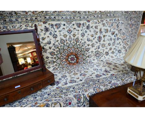 Kashan woollen carpet, fawn ground with a burnt orange floral medallion and dispersed with foliate fronds within a fawn palme