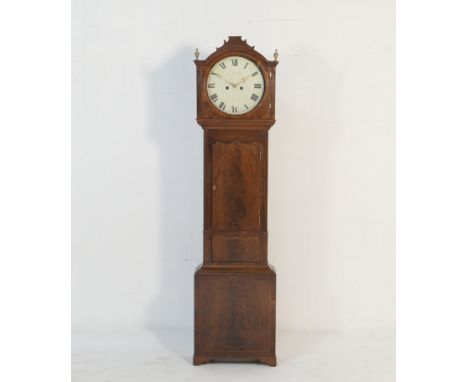 Scottish mahogany eight day longcase clock, circa 1820, the hood with two brass finials flanking a painted 14 ins circular di