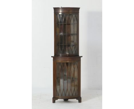 Edwardian mahogany freestanding corner display cabinet, bowfronted and with a single astragal glazed door top and bottom, ope