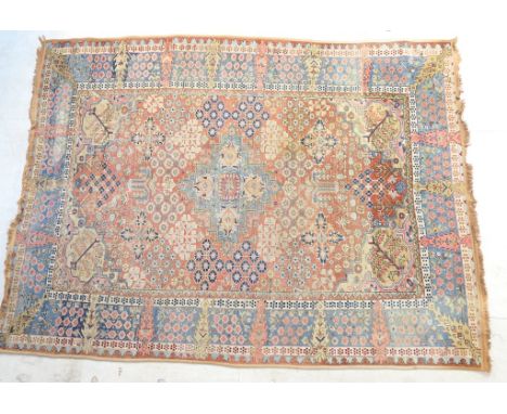 Persian Heriz woollen carpet, faded red field dispersed with floral clusters within a sky blue border, 300cm x 223cm 