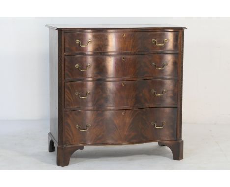 Chippendale Revival mahogany serpentine chest of drawers, the top with moulded edge, over four graduating drawers with brass 