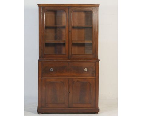 Victorian mahogany secretaire bookcase, having two glazed doors opening to adjustable shelves over a secretaire drawer with p