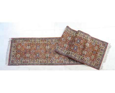 Meshed woollen runner, red field dispersed with coloured palmettes within a fawn floral border, 485cm x 82cm 