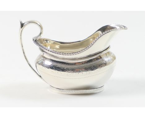 Victorian silver milk jug, by The Barnards, London 1876, helmet shaped and engraved with a band of foliage beneath a gadroone