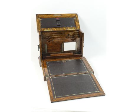 Late Victorian oak stationery and writing box, the case with a hinged cover opening to reveal a comparted interior for letter