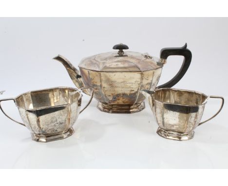 Contemporary silver three piece tea set - comprising teapot of faceted form, with engraved decoration, angular ebonised handl