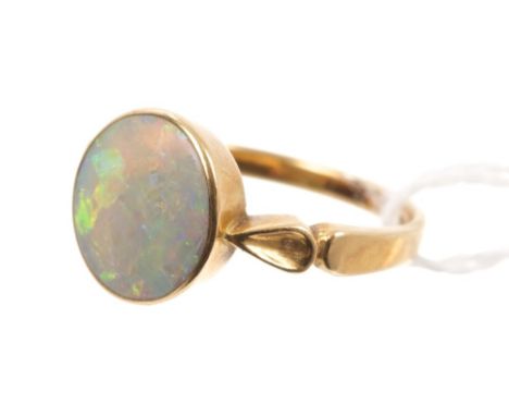 Late Victorian opal ring, the oval opal cabochon measuring approximately 10.3mm x 9.8mm, in a rub-over setting, on gold (18ct