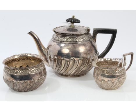 Victorian silver three piece bachelor tea set - comprising teapot of half fluted form, with floral border and flared rim, ang