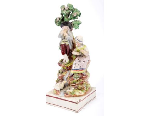 19th century pearlware songster group, depicting a couple playing instruments in a naturalistic setting, beneath them a goose