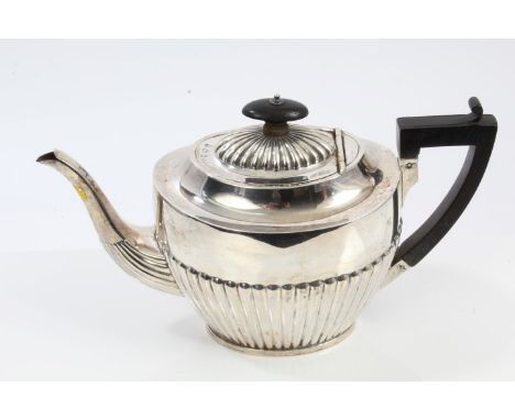 Edwardian silver teapot of reeded Georgian-style form, with ebonised handle and knop, Birmingham 1902