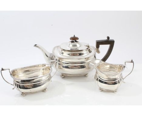 George V silver three piece silver tea set - comprising teapot of compressed baluster form, with fluted corners, gadrooned bo