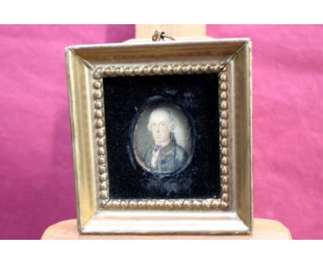 Late 18th / early 19th century English School oval portrait miniature on ivory - a gentleman in blue coat, 3.7cm x 3cm, in gi