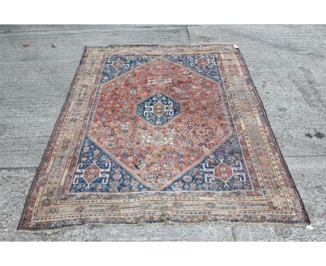 Persian rug with broad hexagonal brick red medallion with allover scattered flower and bird motifs in many spandrels and mult