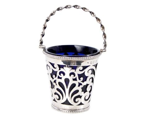 Edwardian silver sugar vase of tapering form, with pierced foliate decoration and bead borders, twisted swing handle and blue