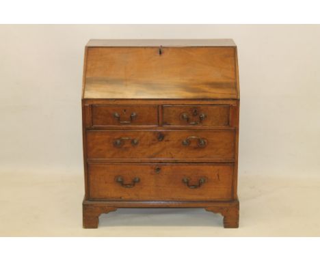 George III mahogany bureau of Horatio Nelson interest with sloped fall enclosing fitted interior and two short over two long 