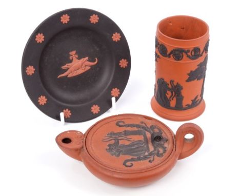 Early 19th century Wedgwood Rosso Antico red cane ware oil lamp and lid after the antique, with black moulded classical femal