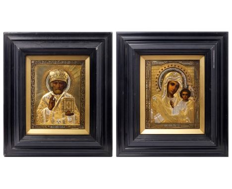 Two similar early 20th century Russian Icons, the first depicting the Mother and Child, the finely tooled silver and gilt okl