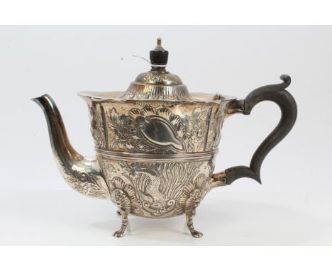 Edwardian silver teapot of tapering form, with embossed panels with animals and birds against a foliate background and flared