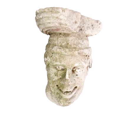 Antique carved stone architectural bracket in the form of a leering male head with hat and neck scarf, traces of paint, proba