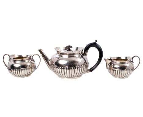 Victorian silver three piece tea set - comprising teapot of bullet form, with raised fluted decoration and flared rims, ebony